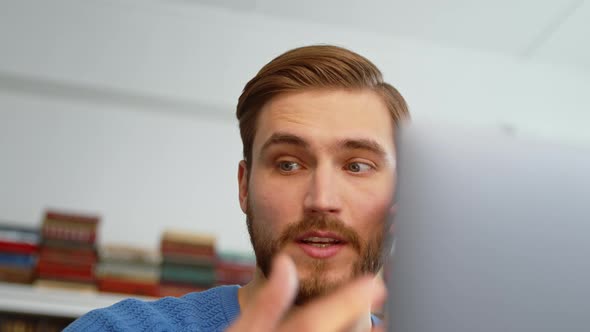 Young male talking using smartphone in his office