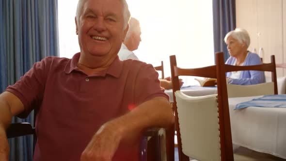 Portrait of happy senior man on wheel chair