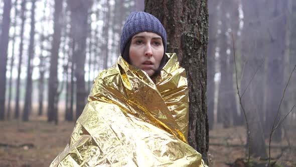 Close Up Lost Hiker Woman Wrapped on Golden Survival Blanket