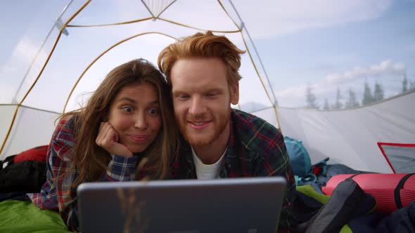Woman and Man Using Digital Tablet in Camping Tent
