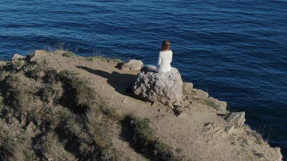 The Concept of Reassurance and Concentration A Woman in White Clothes Sits in a Lotus Position 