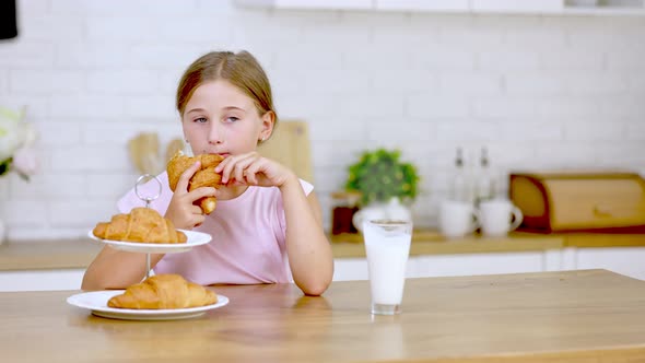 Girl Eating Croissant