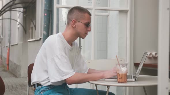 Handsome Caucasian Homosexual Freelancer Businessman Diligently Working on Laptop in Cafe. Man