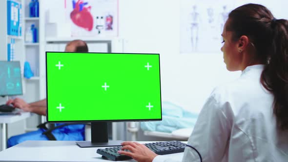 Physician Writing Diagnose on Computer