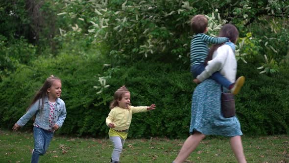 Happy Family Mom Three Little Siblings Kids Have Fun Catch Up Chase Enjoying Summer Holidays in