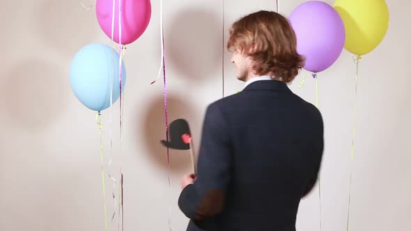 Young man changing props in photo booth