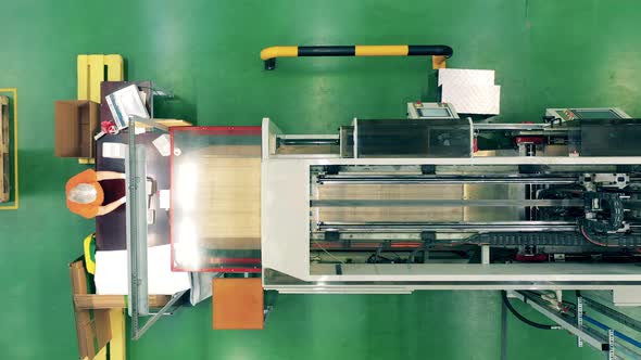 Top View of a Plasticmanufacturing Machine and a Factory Worker