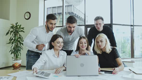 A Group of Young Men and Women Are Busy Working on a Laptop Time Is Not Waiting Employees Are