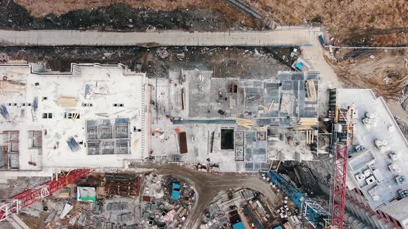 Camera Raises Above Roof of Apartment Building and Cranes alt