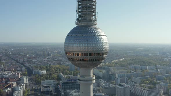 AERIAL: Super Close Up View of the Alexanderplatz TV Tower in Berlin, Germany on Hot Summer Day 