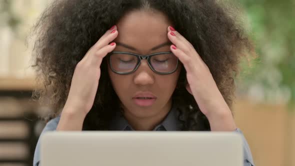 Close Up of African Woman with Laptop Having Headache