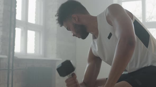 Strong Man Lifting Dumbbell At Workout