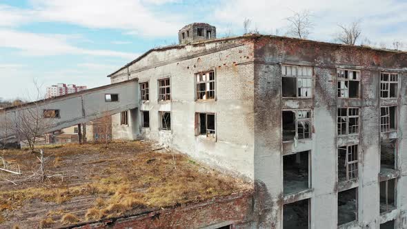 Aerial view of an old factory ruin and broken windows. Old industrial building for demolition.