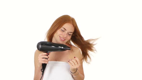 Redhead Woman in Bathroom Drying Hair with Blow Dryer, Bathroom