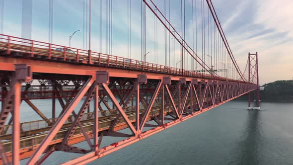 Aerial View of a Train of the Lisbon Metro Passing Along a Suspension Bridge