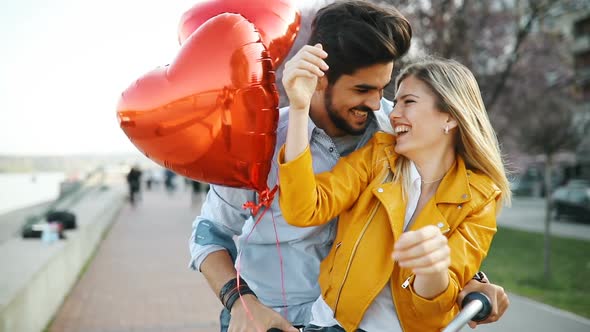 Young Loving Couple Dating While Riding Bicycles in the City