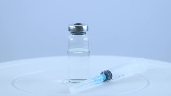 Coronavirus Vaccine and Medical Syringe on White Background