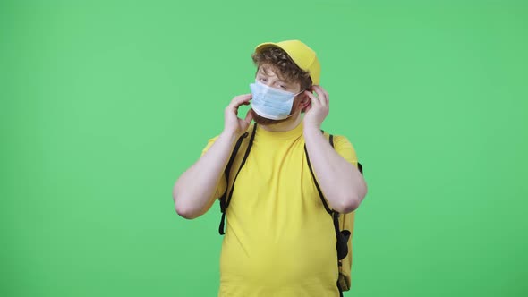 Portrait of Young Men Looking at the Camera and Puts on Medical Mask