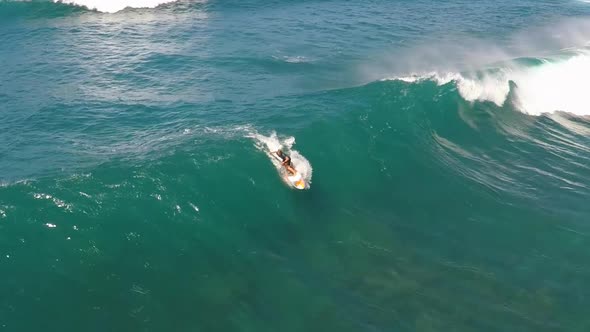 Aerial view of a wipeout while sup stand-up paddleboard surfing in Hawaii.