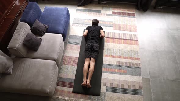 Above Footage of a Man Doing Pushup Exercise at Home