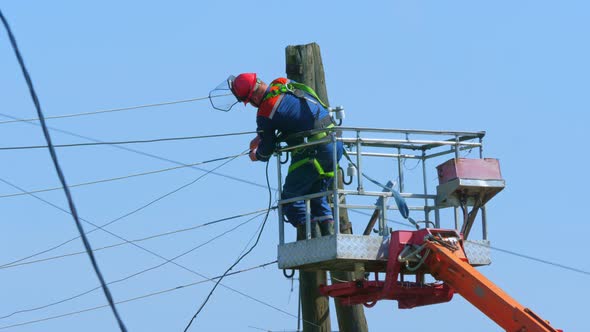 Electrician Repairs Power Lines