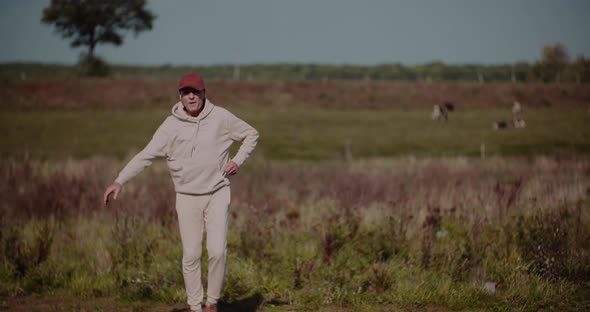 Senior Man Exercising Outdoors in Autumn Sunny Day