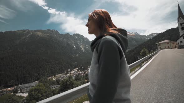 Slow Motion Shot of Happy Young Woman Spinning and Running in the Dolomites Northern Italy in the