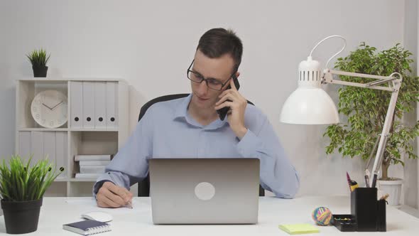 Phone Talk Man Attending Call at Work