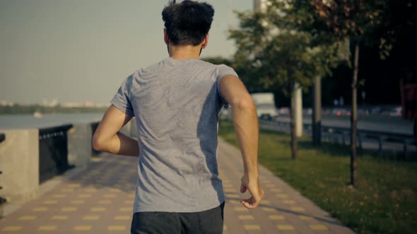 Running Man Fitness Exercising. Athlete Jogging In City. Training Triathlon. Healthy Lifestyle.