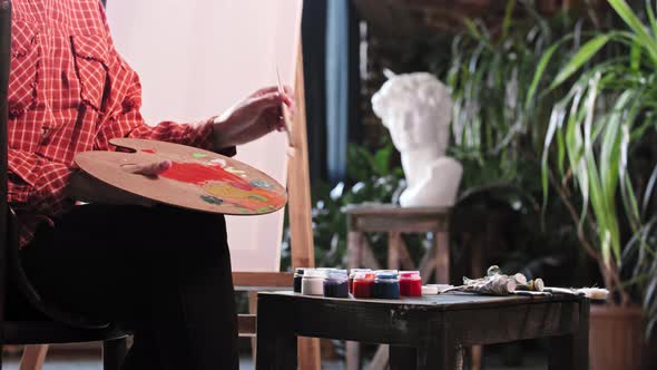 A Young Woman Artist Mixing a Beige Color on the Palette