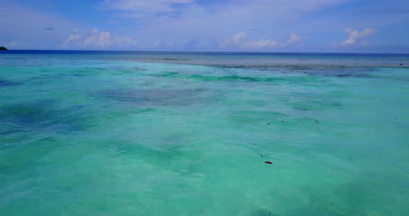 Tropical fly over travel shot of a sunshine white sandy paradise beach and blue water background