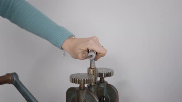 Jeweler's Hand Turning Lever Of A Jewelry Rolling Mill Machine At Workshop