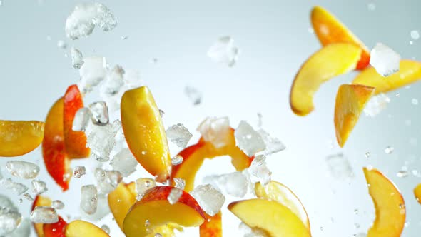 Super Slow Motion Shot of Flying Fresh Peach Slices and Crushed Ice at 1000 Fps