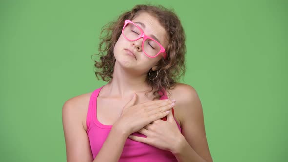 Young Sad Nerd Woman Holding Heart While Looking Down