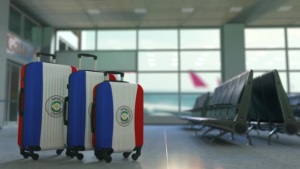 Suitcases with Flag of Paraguay in the Airport Terminal