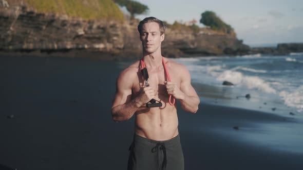 Portrait of Young Caucasian Man Staying at the Seashore After Workout