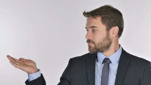 Portrait of Businessman Showing Product at Side White Background