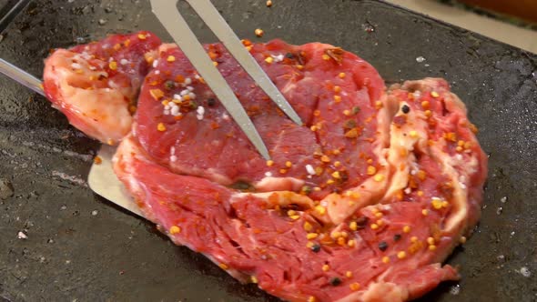 Cook Turns Meat on a Grill