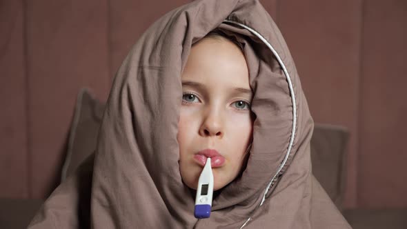 Teen Girl Holds Thermometer in Mouth Measuring Temperature