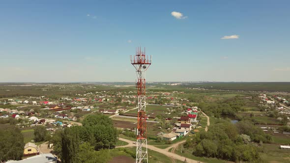 Aerial shot of telecommunication antenna tower in a rural location.
