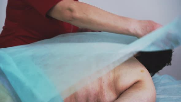 Doctor in Uniform Cleans Woman Back From Honey on Couch