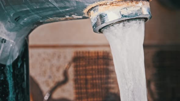 Macro Shot of Faucet with Running Water in Slow Motion