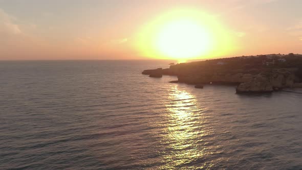 Aerial view of the ocean shore at sunset