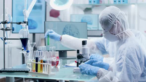 Two Researchers in Modern Laboratory in Coverall