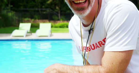 Happy lifeguard at pool side