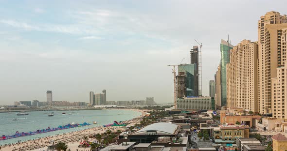 Aerial View of Beach and Tourists Walking in JBR with Skyscrapers on Background Day to Night