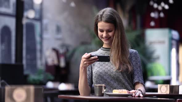 Beautiful Woman Making Food Photo On Mobile Phone At Cafe