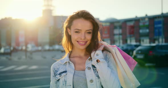 The Woman is Going and Looking at the Camera