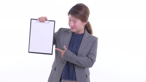 Happy Young Asian Businesswoman Showing Clipboard and Giving Thumbs Up