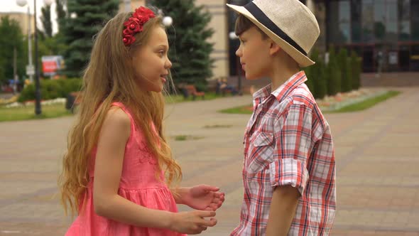 Little Boy and Girl Talk Outdoors